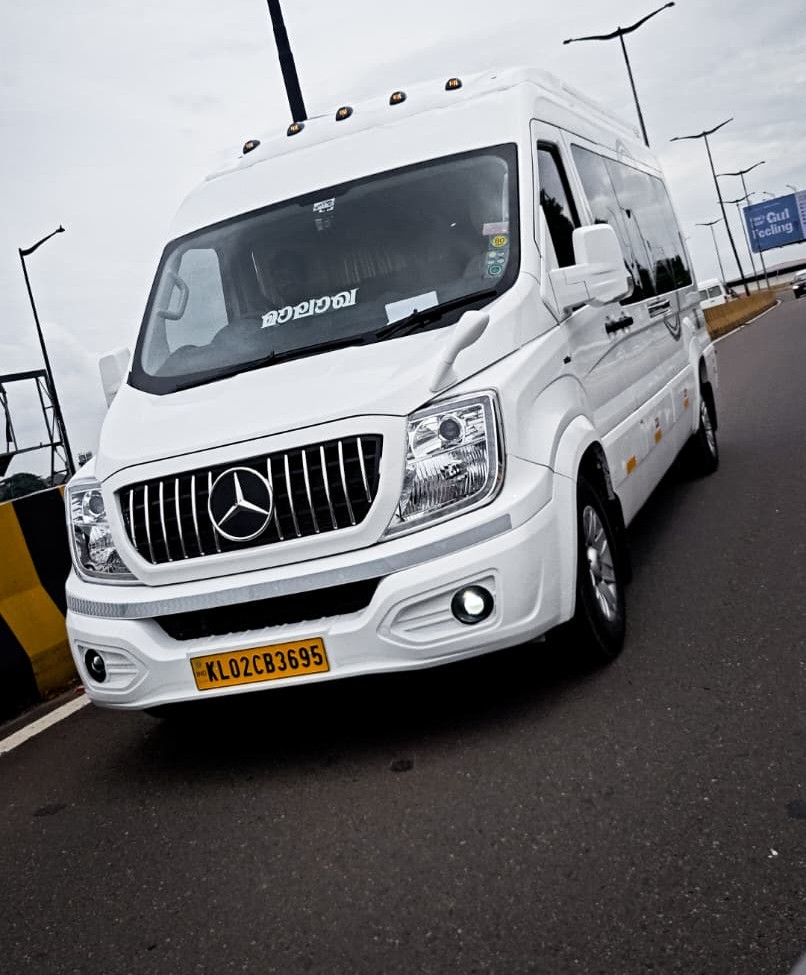 White Force Urbania van on the highway for premium group travel in Kerala